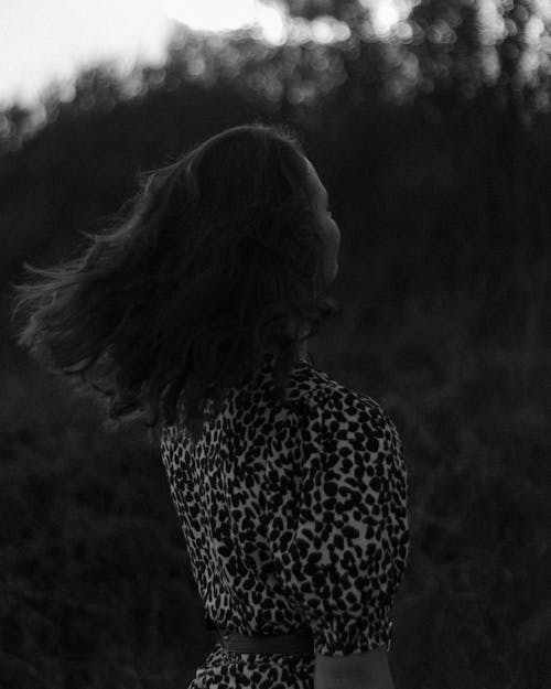 A Grayscale Photo of a Woman in Printed Shirt