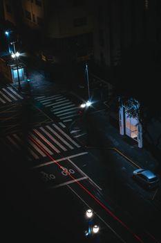 Aerial view of São Paulo street at night with car light trails and street lamps.