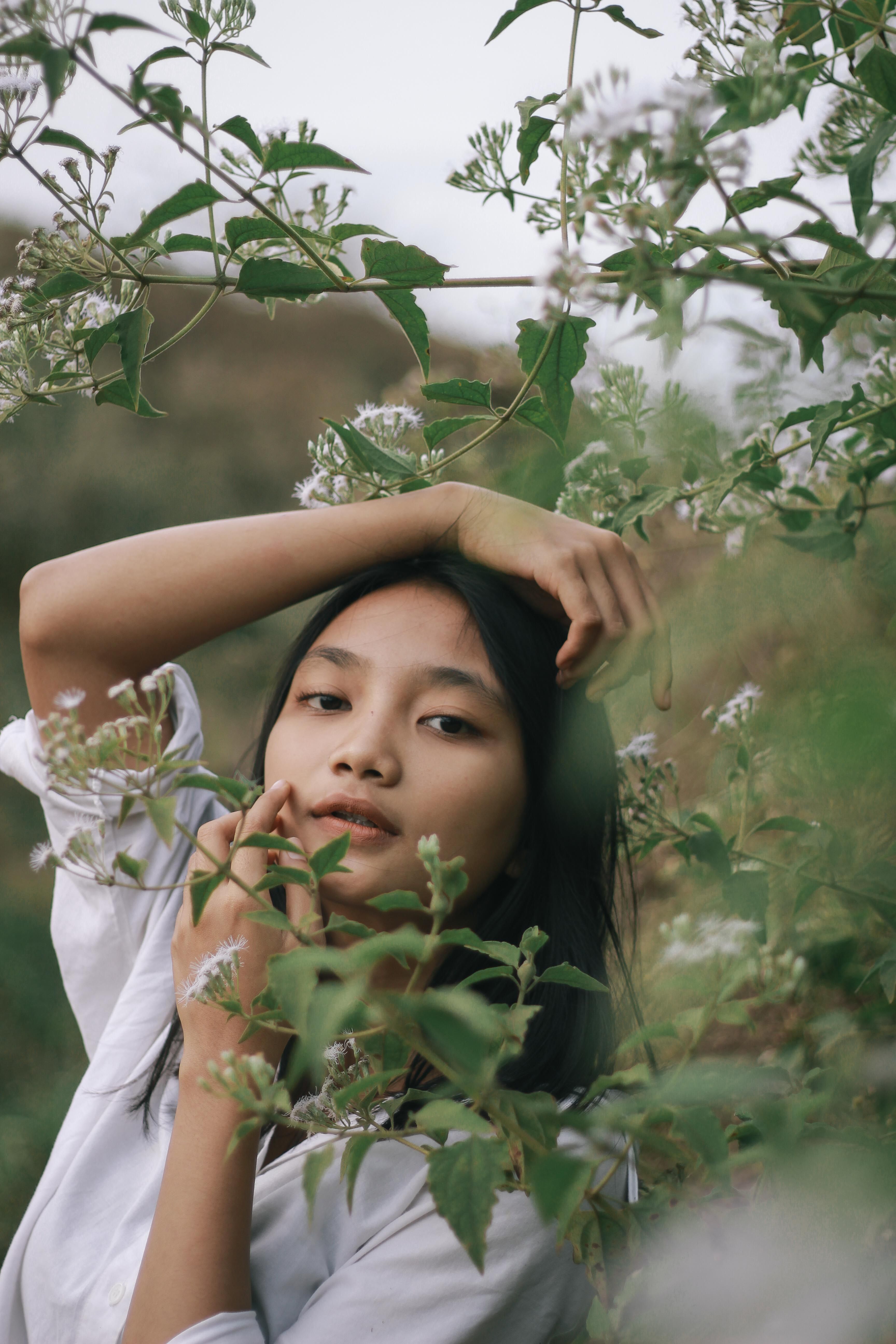 Woman in White Shirt Standing Under Green Tree · Free Stock Photo