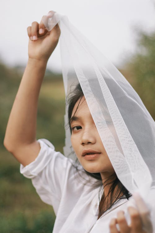 Woman Holding a Cloth near her Head