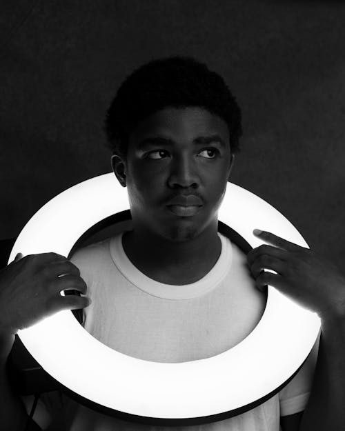 Free Grayscale Photo of a Man Holding a Ring Light Stock Photo