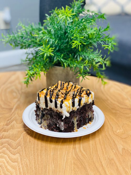 A Slice of Butterfinger Poke Cake on a Plate