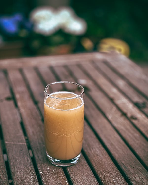 An Apple Juice in a Clear Drinking Glass