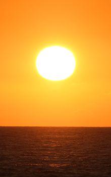 Breathtaking sunset over the ocean, creating a vibrant and serene atmosphere.