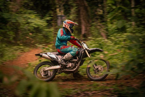 Man in Blue Jacket Riding Motorcycle