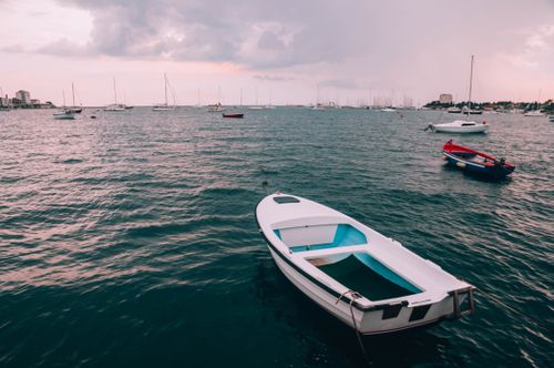Free Serene seascape with boats drifting on the Adriatic Sea under a cloudy sky. Stock Photo