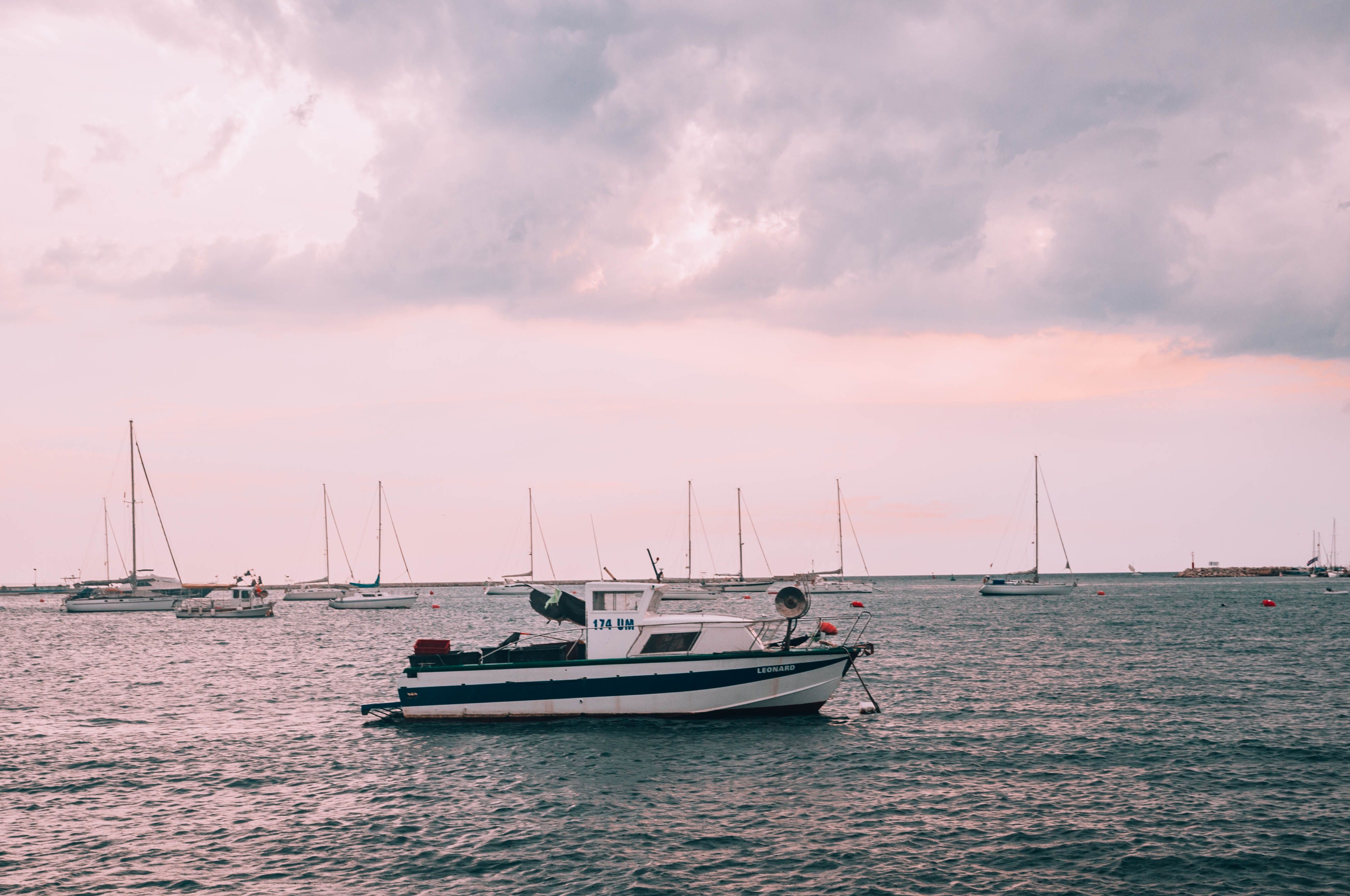 White and Blue Boat on Sea Under Cloudy Sky · Free Stock Photo