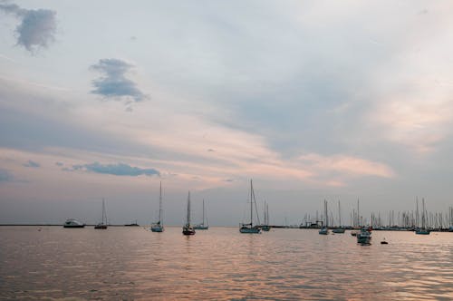 Free Boats Sailing on the Sea during Sunset Stock Photo