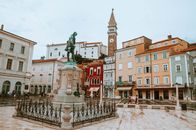 Street Landscape on the Central Square with a Monument and an Ancient Watch Tower in Piran, Slovenia