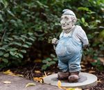 Man in Blue Dress Shirt Holding Brown Wooden Stick Figurine