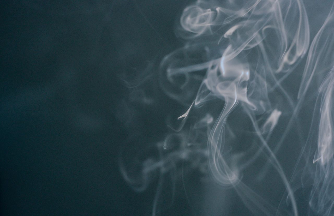 close up of swirling smoke patterns on a dark background ideal for wal