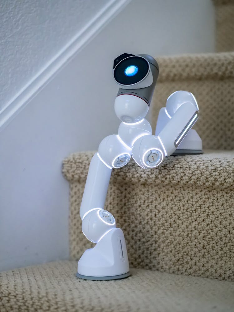 White Ai Robot On The Stairs