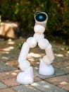 White Robot Toy on Pavement