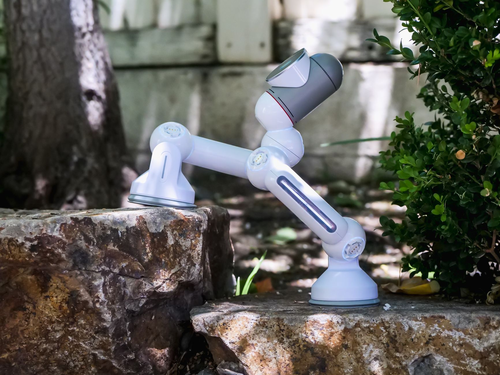 A modern robot traversing rocky outdoor terrain, showcasing advancements in robotic technology.
