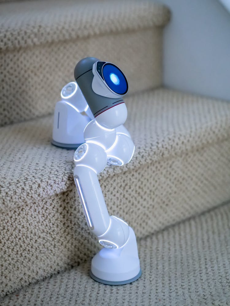 Gray And White Robot Walking On Stairs