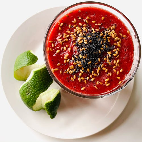 Close Up Photo of Red Soup in Glass Bowl