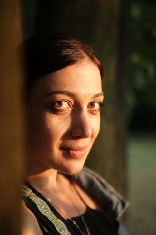 Free Close-up portrait of a woman in soft natural light during sunset. Stock Photo