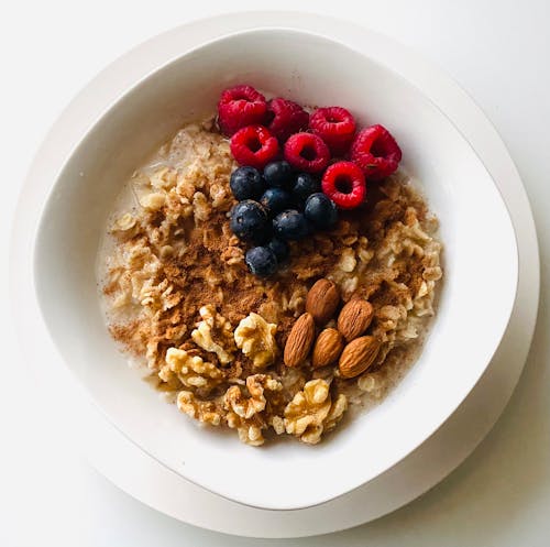 An Oatmeal Tops with Nuts and Fresh Fruits