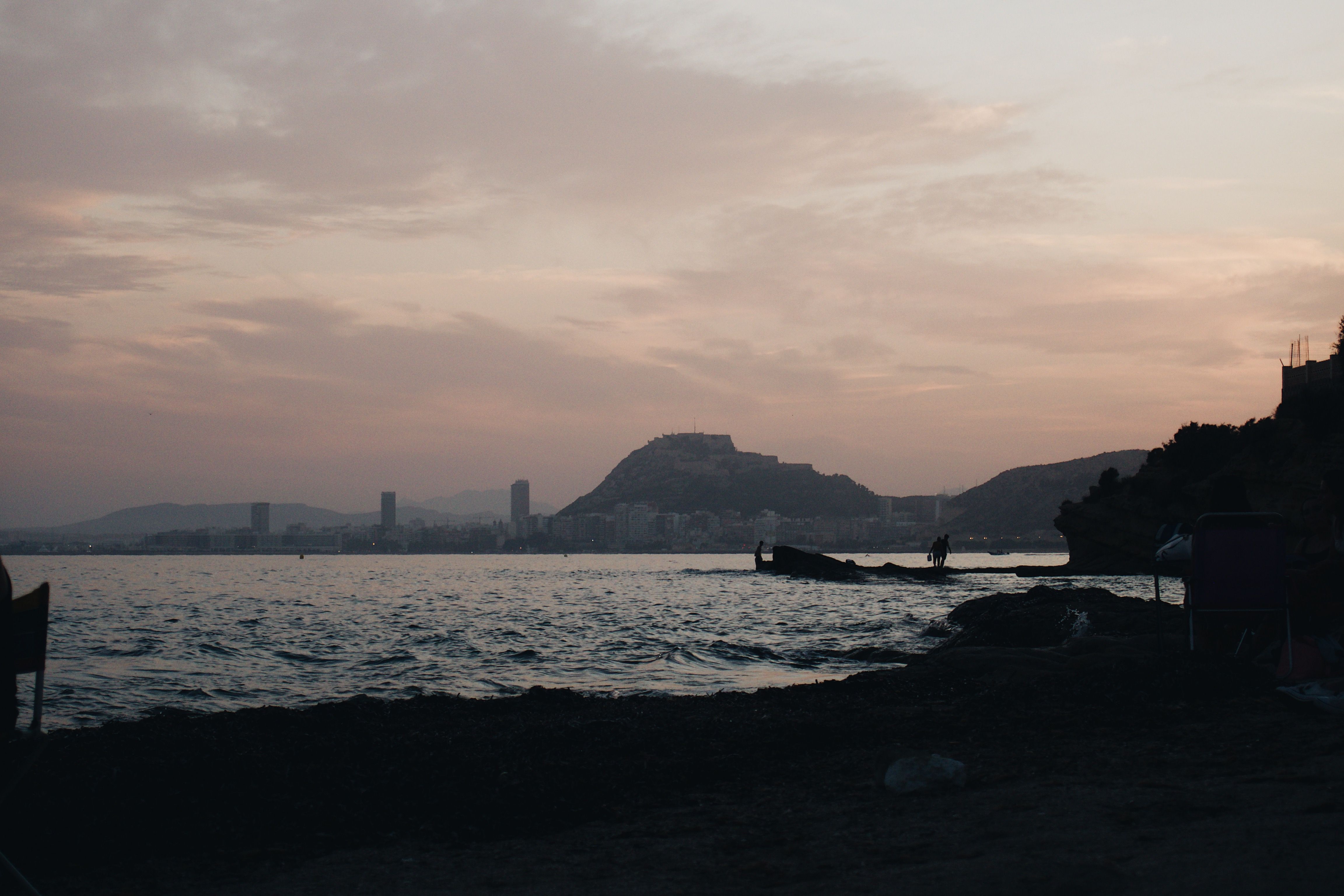 Silhouette of Mountain Near Body of Water during Sunset · Free Stock Photo