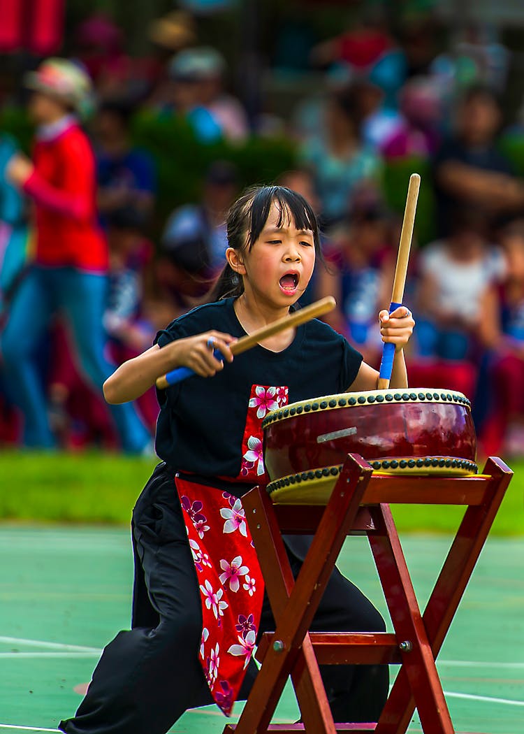 Girl In Black Dress Playing Drum