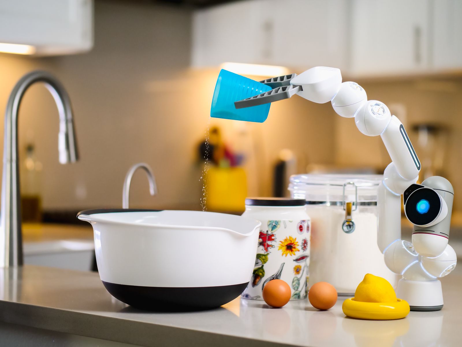 A robotic arm pouring ingredients into a mixing bowl in a modern kitchen, photo by Kindel Media on Pexels