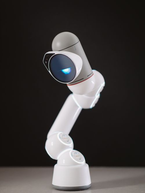 Free A sleek, modern robotic arm with illuminated features in a professional studio setting. Stock Photo