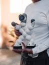 Person in White Long Sleeves Holding a Clicbot