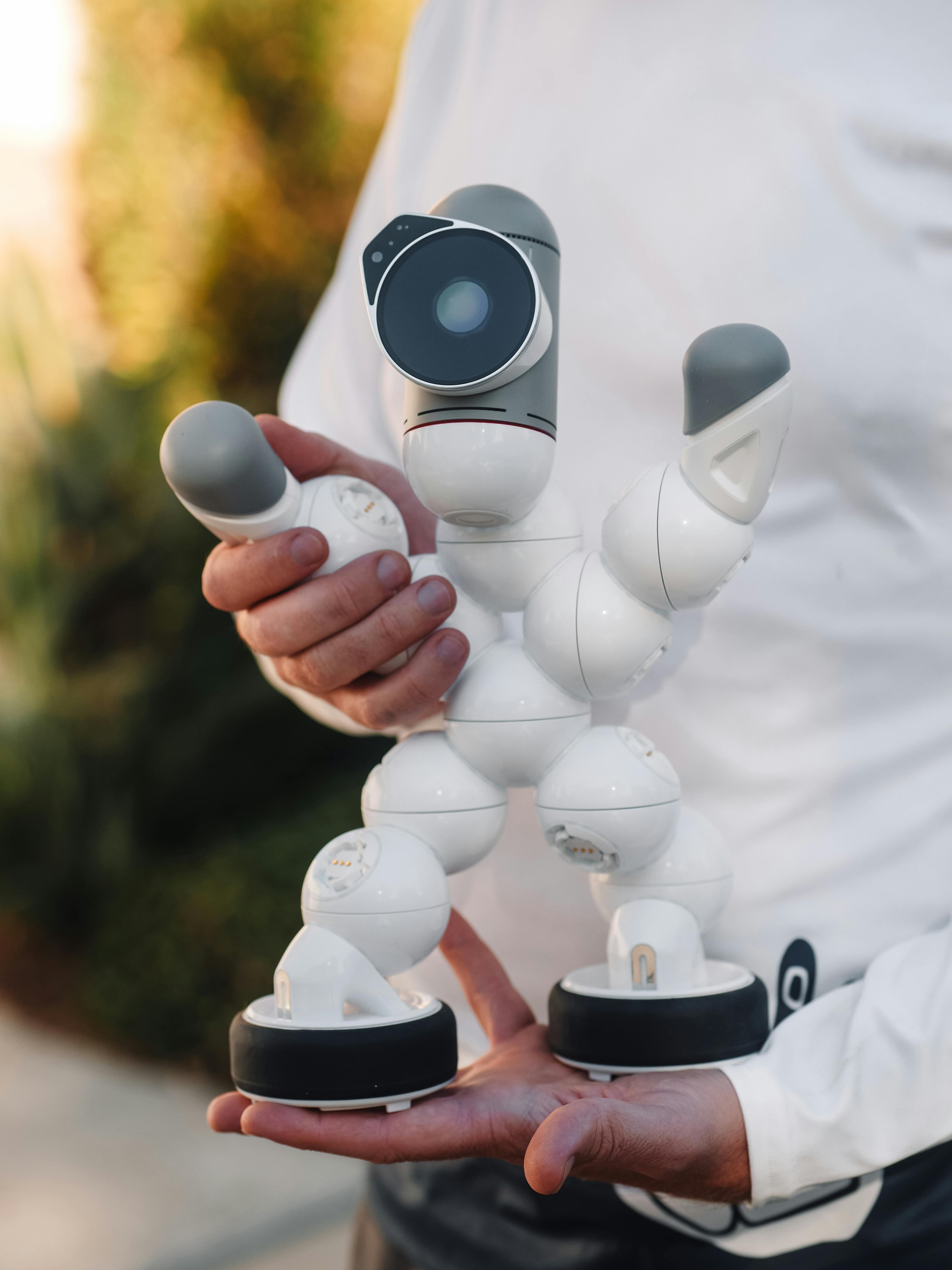 a person holding a white robot