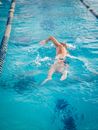 Woman in Blue Bikini Swimming in Pool
