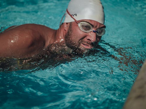 Woman in Swimming Goggles in Water