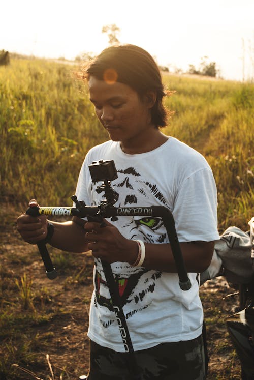 Man With White Black Shirt in Field