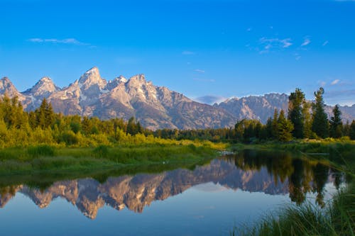 Free Mountains and Trees Reflecting in the Lake Stock Photo