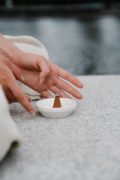 Woman Putting on the Table Conical Incense Burner 