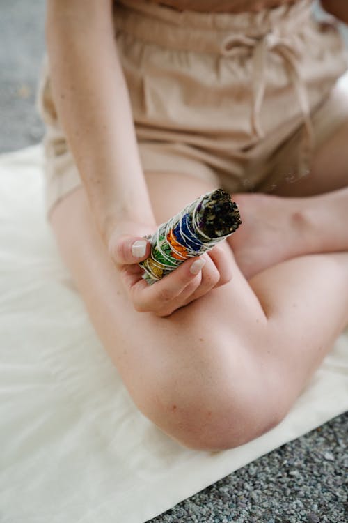 A Person Holding a Burning Sage Incense