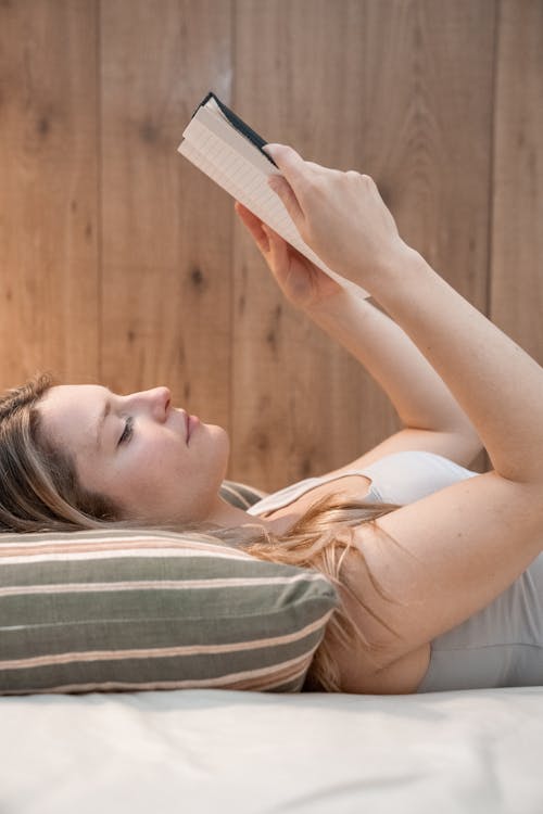 Free Woman in White Gray Tank Top Reading Book Stock Photo