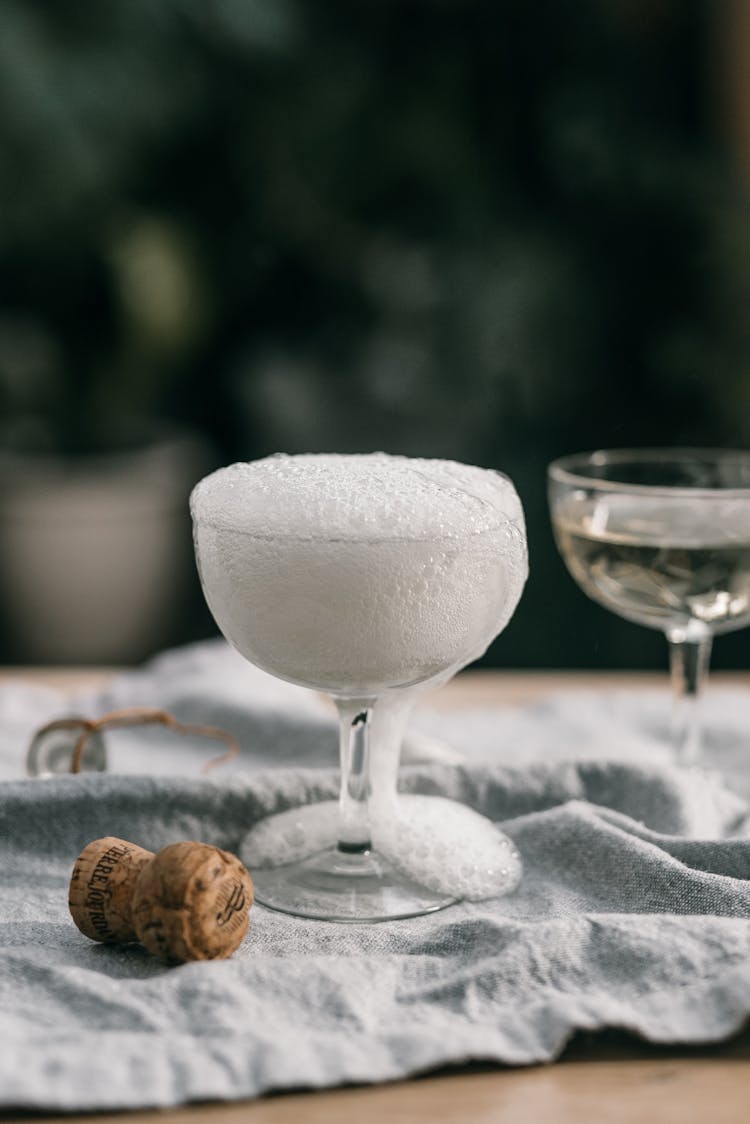 White Bubble Overflowing On Clear Wine Glass