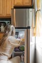 Woman Getting Some Foods in the Refrigerator