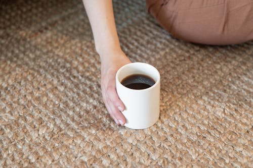 Close-Up Shot of a Person Holding a Cup of Coffee