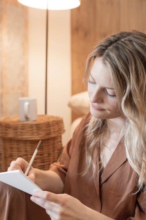 Free Beautiful Woman Writing on a Paper Stock Photo