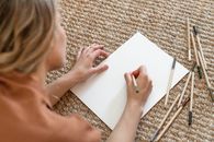 Woman Writing on White Printer Paper