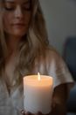 Woman in White Shirt Holding White Candle