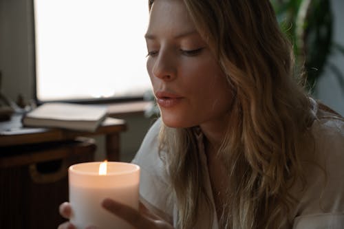 A Woman Blowing the Candle