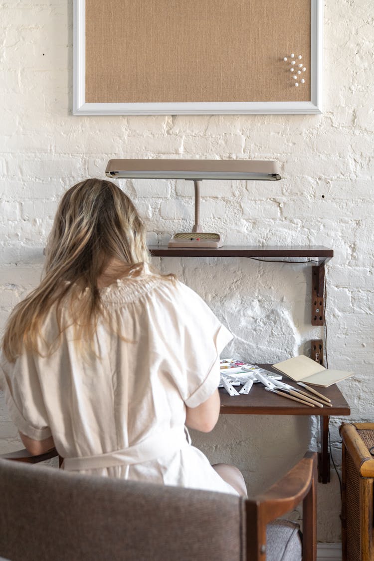 Woman Sitting On Chair By Table