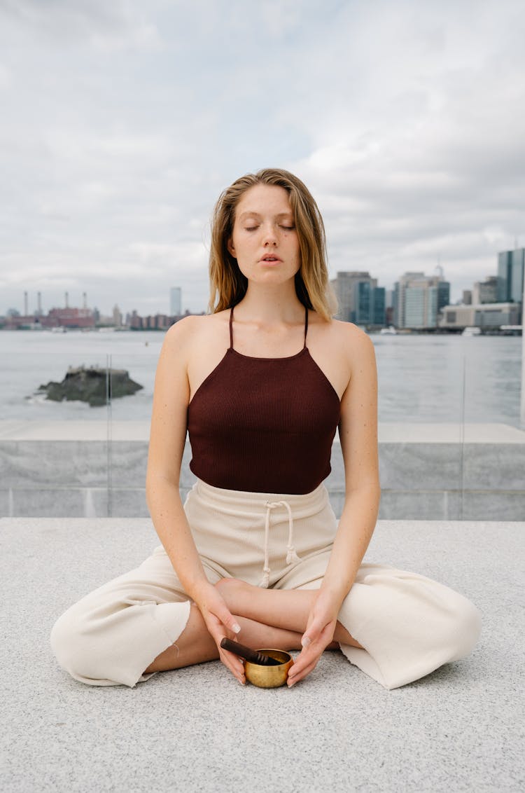 Woman Meditating In City 