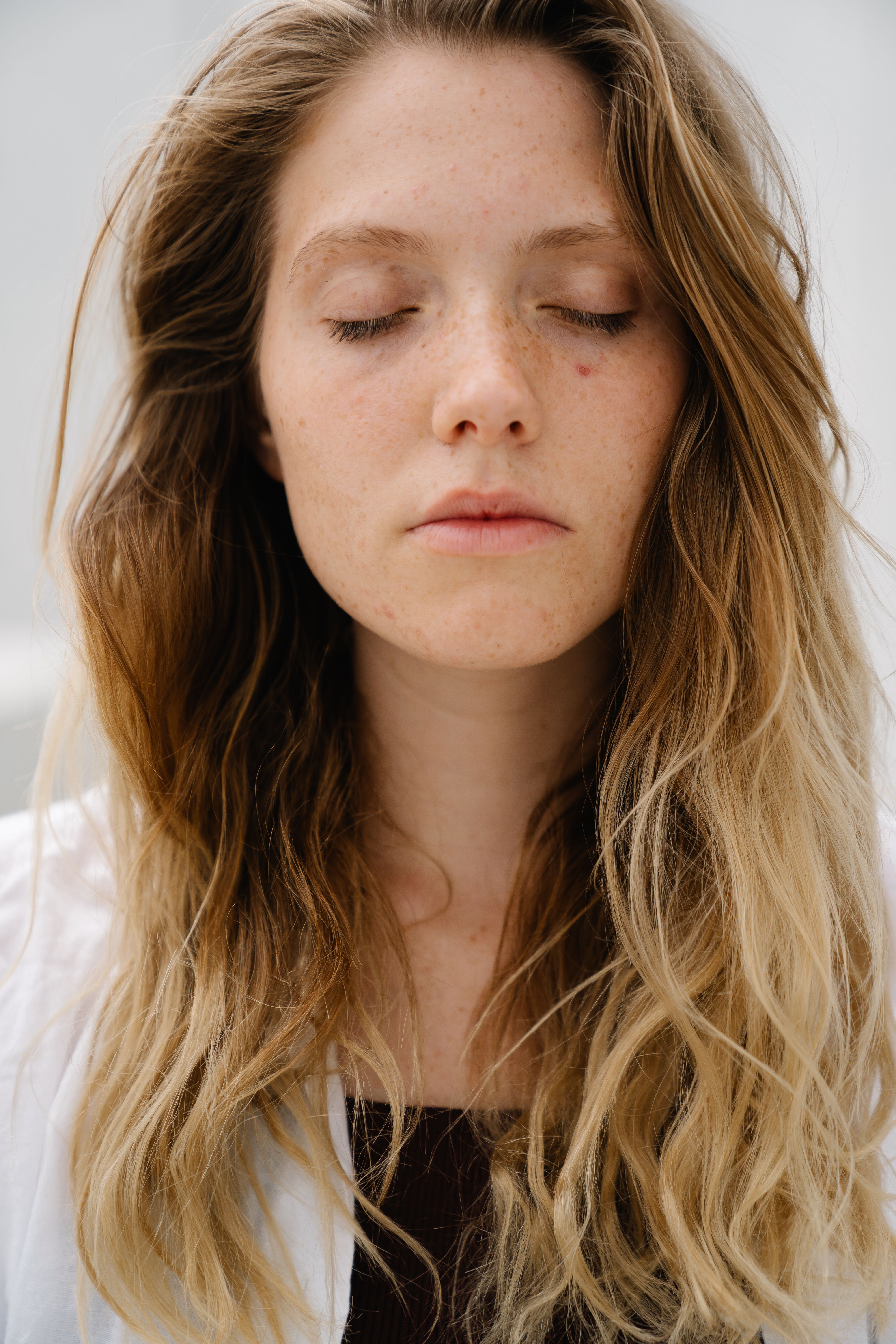 A serene close-up portrait of a young woman with closed eyes, embodying tranquility.