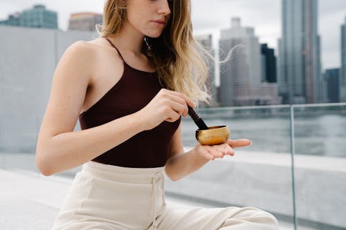 woman meditating in front of city landscape 