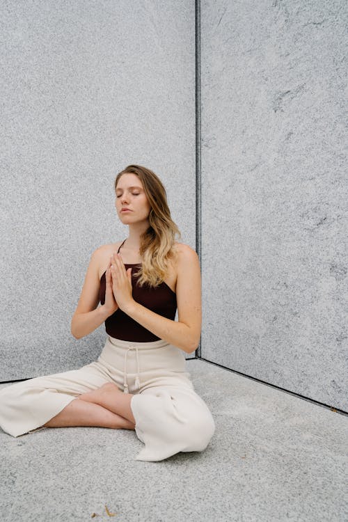 Free A Woman Meditating with Her Hands Together Stock Photo