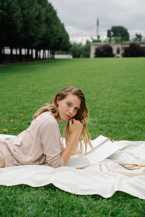 Woman Lying on Blanket on Grass