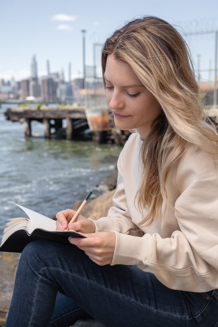 Woman Writing In A Notebook 