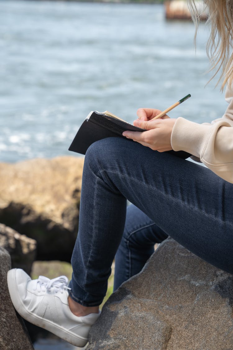 Legs Of Woman With Notebook